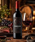 Porkoláb Cuvée Hungarian red wine bottle beside a glass of red wine and steak