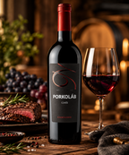 Porkoláb Cuvée Hungarian red wine bottle beside a glass of red wine and steak