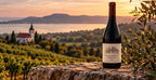 Szentesi Tihanyi Kék 2025 bottle overlooking vineyards at sunset